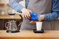 Male barista making pourover coffee, scaling coffee with digital scale. Royalty Free Stock Photo