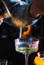 Male bartender holds fired up sugar above delicious alcohol cocktail. Extream fired coctail Royalty Free Stock Photo