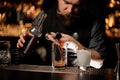 Male bartender pouring an alcohol cocktail with jigger Royalty Free Stock Photo