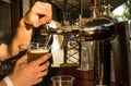 The male bartender pouring beer into a glass close-up. Street food Royalty Free Stock Photo