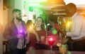 Male bartender shaking cocktail mixer for couple at nightclub Royalty Free Stock Photo