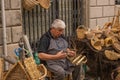 A male basket weaver at a craft market in a hilltop town in Italy
