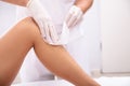 Beautician Waxing Woman`s Leg