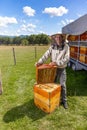 Male beekeeper wearing protective costume