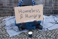 Male Beggar Lying On Street