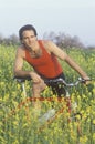 Male bicyclist in field of Spring flowers, Malibu, CA