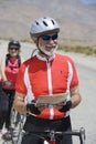 Male Bicyclist Holding Map With Woman In The Background Royalty Free Stock Photo