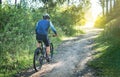 Male bicyclist riding his mountain bike up a mountain trail