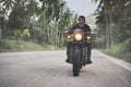 Motorbike on the palm trees road riding. driving the empty road on a motorcycle tour journey. Royalty Free Stock Photo