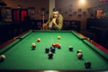 Male billiard player with cue thinking how to hit