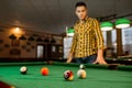 Male billiard player with cue, view from the table Royalty Free Stock Photo