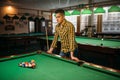 Male billiard player, poolroom on background Royalty Free Stock Photo