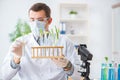 The male biochemist working in the lab on plants