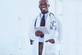 Male black doctor worker with tablet computer standing in hospital