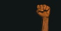 Male black fist on a black background. Aggressiveness, masculinity, the concept of challenge