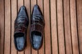 Male black shoes over the wooden table Royalty Free Stock Photo