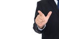 Male in black suit in front of white background stretches out his right hand to make click gesture