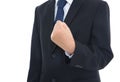 Male in black suit makes an effort gesture with his left hand fisted Royalty Free Stock Photo