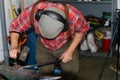 Male blacksmith in his smithy workshop