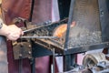 Male blacksmith working in workshop, London. Concept