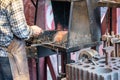 Male blacksmith working in workshop, London. Concept