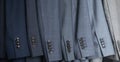 Male blazer coat and necktie neatly hanging at cupboard comfortable storage organization closeup