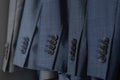 Male blazer coat and necktie neatly hanging at cupboard comfortable storage organization closeup