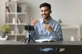 Male blogger make speech on smartphone camera, stand on tripod