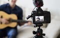 Male blogger recording music related broadcast at home Royalty Free Stock Photo