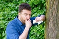 Male blowing his nose outdoors, having problem with allergy Royalty Free Stock Photo
