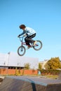 Male bmx biker doing trick on ramp in skatepark Royalty Free Stock Photo