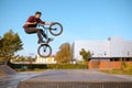 Male bmx biker jumps on ramp in skatepark Royalty Free Stock Photo