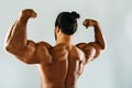 Male bodybuilder posing in studio, showing biceps Royalty Free Stock Photo