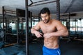 Male bodybuilder resting near parallel bars