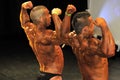 Male bodybuilding contestant showing his back double biceps pose