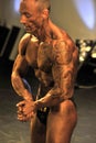 Male bodybuilding contestant showing his chest pose