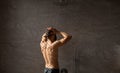 Rear back view of young man washing his body and head Royalty Free Stock Photo