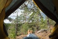 Male boots looking out of the tent during rest after hiking. Royalty Free Stock Photo