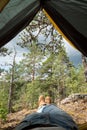 Male boots looking out of the tent during rest after hiking. Royalty Free Stock Photo