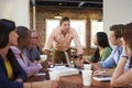 Male Boss Addressing Office Workers At Meeting Royalty Free Stock Photo
