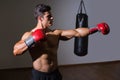 Male boxer attacking with his left in health club