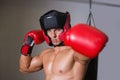 Male boxer attacking with his left in health club