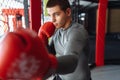 Male boxer engaged in training in the gym, in a cage for a fight