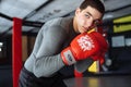 Male boxer engaged in training in the gym, in a cage for a fight