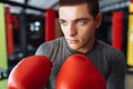 Male boxer engaged in training in the gym, in a cage for a fight