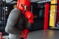 Male boxer engaged in training in the gym, in a cage for a fight without rules, Boxing coach