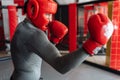 Male boxer engaged in training in the gym, in a cage for a fight without rules, Boxing coach