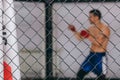 Male boxer exercising muscles during body core crossfit workout indoor