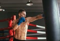 Male boxer hitting punching bag at a boxing studio