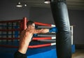 Male boxer hitting punching bag at a boxing studio